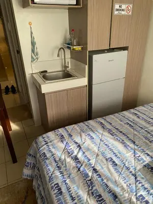 a small kitchen with a sink and a counter top at Pierrecondotel in Manila