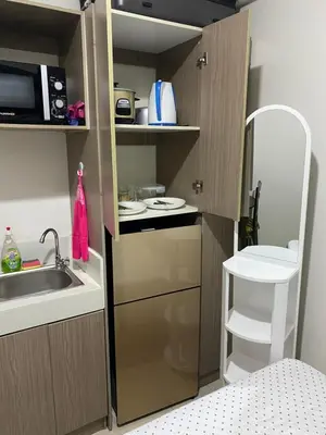 a small kitchen with a sink and a microwave at Pierrecondotel in Manila
