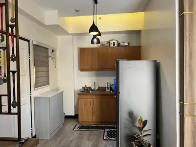 a kitchen with a refrigerator and a sink at 1 Bedroom Penthouse Condo Near Airport NAIA in Manila