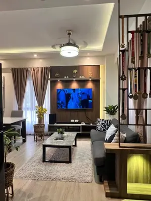 a living room with a couch and a tv at 1 Bedroom Penthouse Condo Near Airport NAIA in Manila