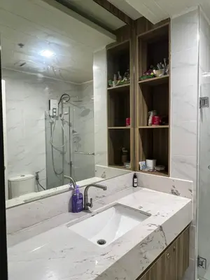 a white bathroom with a sink and a shower at 1 Bedroom Penthouse Condo Near Airport NAIA in Manila