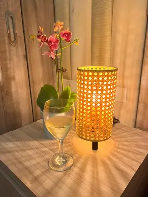 a vase and a glass on a table next to a lamp at 1 Bedroom Penthouse Condo Near Airport NAIA in Manila