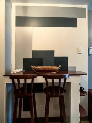 a counter with two chairs and a basket on top of it at Casa R and R Cozy Staycation at S Residences in Manila