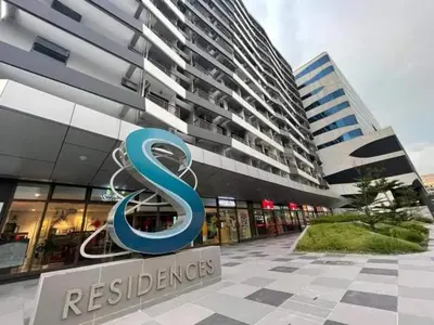 a building with a blue s sign in front of it at Casa R and R Cozy Staycation at S Residences in Manila