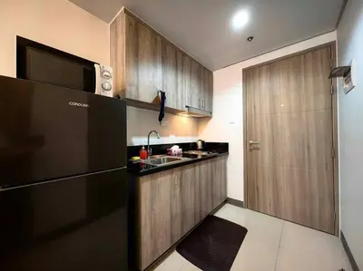 a small kitchen with a sink and a microwave at Casa R and R Cozy Staycation at S Residences in Manila