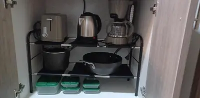 a kitchen shelf with pots and pans on it at Casa R and R Cozy Staycation at S Residences in Manila