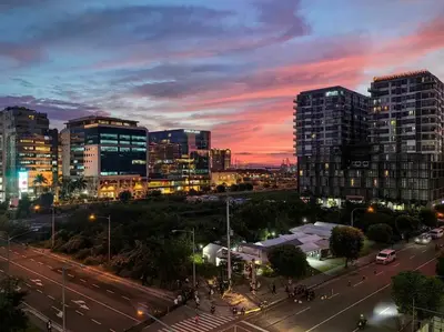 a city skyline with buildings and a street at night at Casa R and R Cozy Staycation at S Residences in Manila