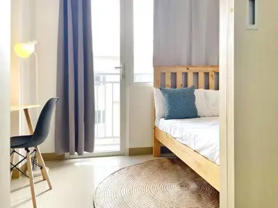 a bedroom with a bed and a desk and a window at 1-Bedroom Condo in Las Piñas in SM SouthMall in Manila