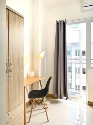 a desk and a chair in a room with a window at 1-Bedroom Condo in Las Piñas in SM SouthMall in Manila