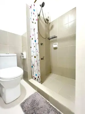 a bathroom with a toilet and a shower at 1-Bedroom Condo in Las Piñas in SM SouthMall in Manila