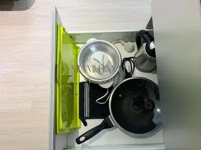 a drawer with a pan and other utensils at Miami Haven at Azure in Manila