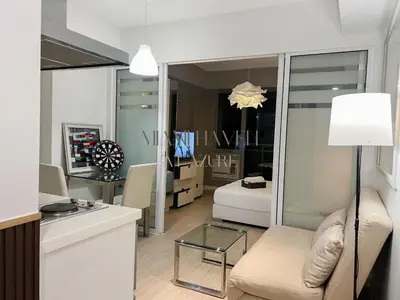 a living room with a couch and a table at Miami Haven at Azure in Manila