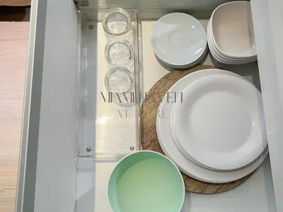 a group of plates and bowls in a drawer at Miami Haven at Azure in Manila