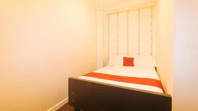 a small bedroom with a small bed in a room at RedDoorz at Emperor Manila Boutique Hotel in Manila