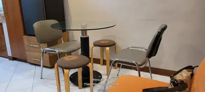 a table and four stools in a room at COMFY 1-BR Condo near SLEC, US Embassy, Malls,Park in Manila