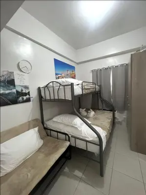 a room with two bunk beds in a room at POEA Mega Mall WiFi Netflix in Manila
