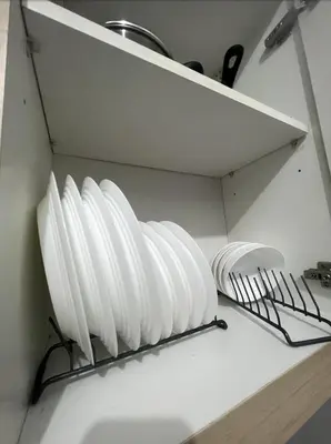 a group of white plates on a shelf in a kitchen at POEA Mega Mall WiFi Netflix in Manila