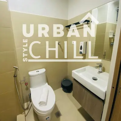 a bathroom with a toilet and a sink at Urban Style Chill, Shore 3, MOA Complex, Pasay, Manila in Manila