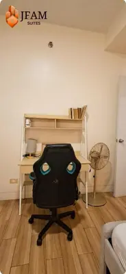 a desk with a bag on a chair in a room at JFam Suites, C1-5L 1BR , Up To 7 Pax in Biñan