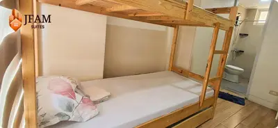 a bunk bed in a small room with a toilet at JFam Suites, C1-5L 1BR , Up To 7 Pax in Biñan