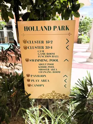 a sign for a holland park on a tree at JFam Suites, C1-5L 1BR , Up To 7 Pax in Biñan