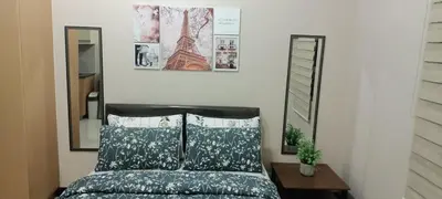 a bedroom with a bed and two mirrors at Condotels near and across Terminal3 Airport in Manila