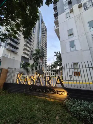 a sign in front of a building with tall buildings at 1BR Cozy Condo at Kasara Urban Resort Pasig City in Manila