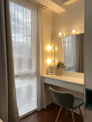a bathroom with a desk and a window with a mirror at 1BR Cozy Condo at Kasara Urban Resort Pasig City in Manila