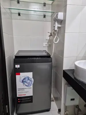a trash can in a bathroom with a phone at 1BR Cozy Condo at Kasara Urban Resort Pasig City in Manila