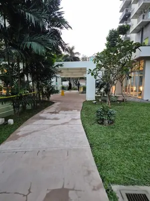 a walkway in front of a building with trees at 1BR Cozy Condo at Kasara Urban Resort Pasig City in Manila