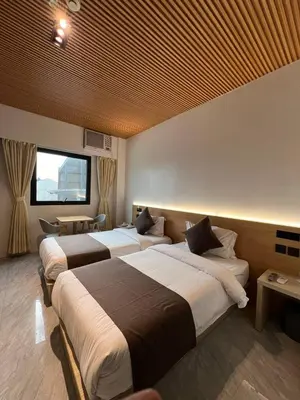 a hotel room with two beds and a window at Terra Hotel Kawit in Kawit