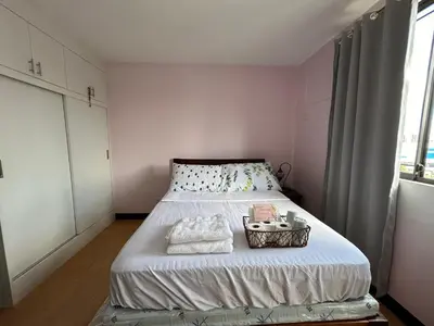 a small bedroom with a bed with a basket on it at Solstay in Manila