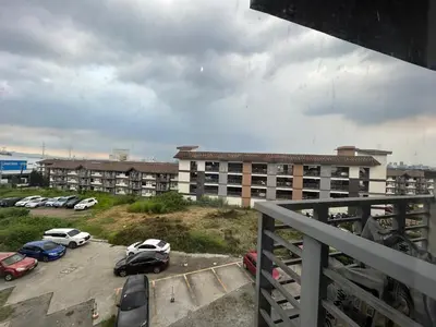 a parking lot with cars parked in front of a building at Solstay in Manila