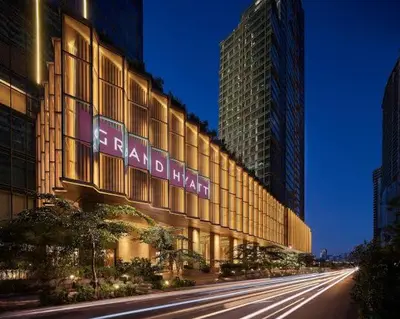 a building with a sign on the side of a street at LUXESTAYSMNL Parisian Charm 1BR Suite Pool Gym 400MBPS WiFi Netflix Amazing City View in Manila