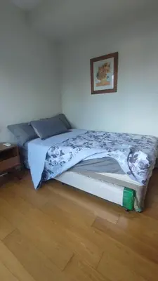 a bed in a bedroom with a picture on the wall at Aveline Suites, Garden City view, 2br, amenities in Manila