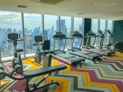 a gym with a row of treadmills and exercise bikes at Aveline Suites, Garden City view, 2br, amenities in Manila