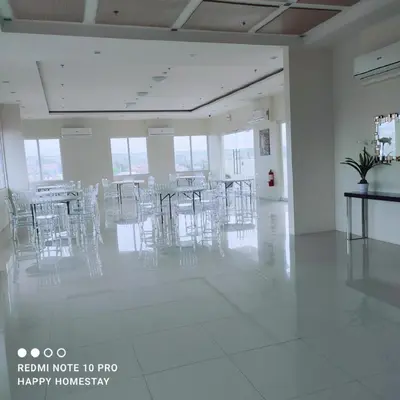 a room with chairs and tables in a building at Happy Homestay at Fullerton Suites Condo near Nuvali and Tagaytay in Silang