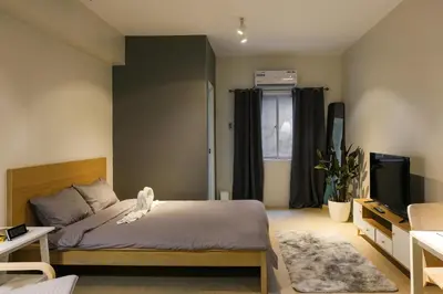 a bedroom with a bed and a television in it at Siesta Spaces Adela in Manila