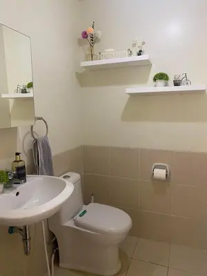 a bathroom with a white toilet and a sink at Brixton place near bgc in Manila