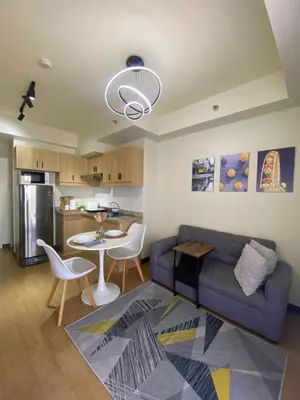 a living room with a couch and a table at Brixton place near bgc in Manila