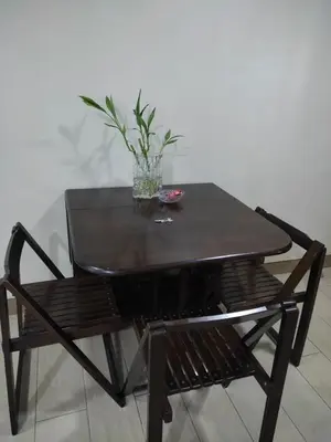 a black table and a chair with a plant on it at LDN Studio Unit Two Palm Tree in Manila