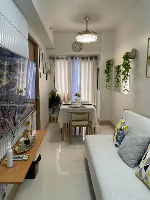 a living room with a table and a couch at Molly Shore Getaway Unit 1276 in Manila