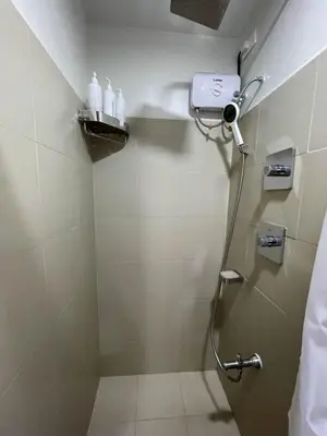 a bathroom with a shower with a shower head at Molly Shore Getaway Unit 1276 in Manila