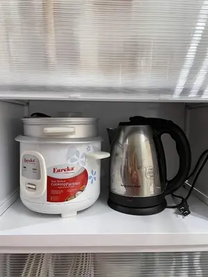 two appliances sitting on a shelf in a refrigerator at Molly Shore Getaway Unit 1276 in Manila