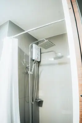 a shower in a bathroom with a glass door at The House of Five - Brand New Hotel Style Condo in Manila