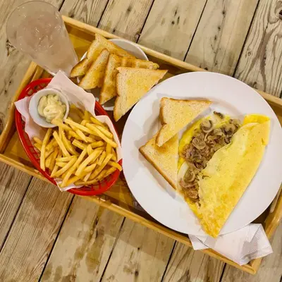 a tray of food with a sandwich and french fries at Cheese Hostel Manila in Manila