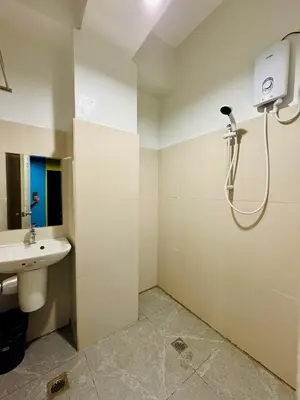 a bathroom with a sink and a shower at Cheese Hostel Manila in Manila