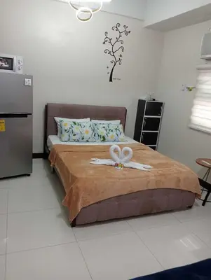 a bedroom with a bed with a bow on it at Newport 101 - East Wing in Manila