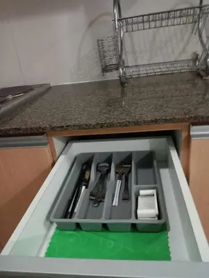 a kitchen counter with a drawer with utensils at Newport 101 - East Wing in Manila