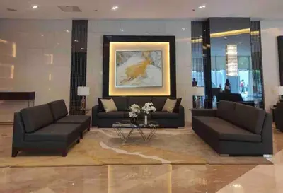 a living room with two couches and a table at Casa Jezhuel at Fame Residences in Manila